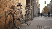 Commuter bike against a brick wall with a compact tool on the saddle
