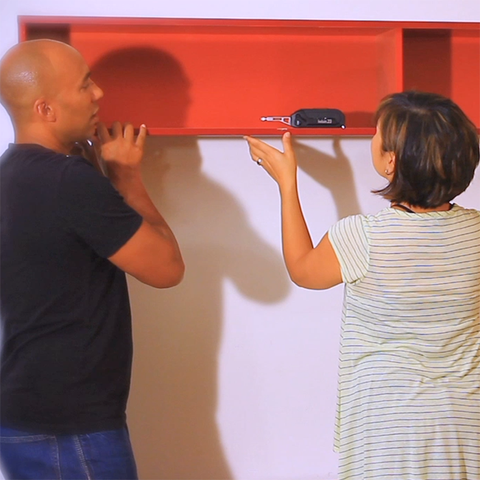 Two people hanging a shelf with a Kelvin multitool