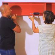 Two people hanging a shelf with a Kelvin multitool